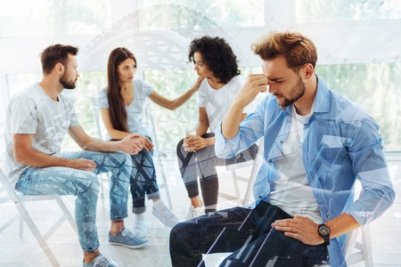 Sad friends having discussion with psychologistの写真素材