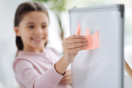 Selective focus of a pink sticky noteの写真素材