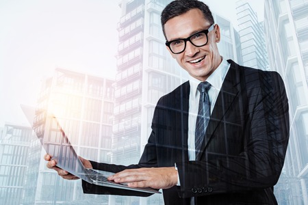 Smart positive businessman being at workの写真素材