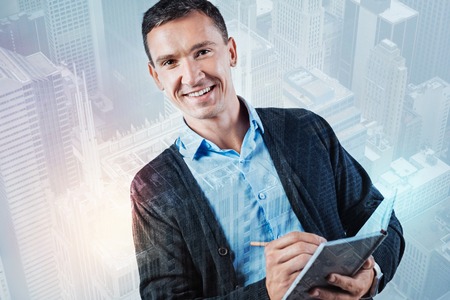 Delighted positive man planning his dayの写真素材