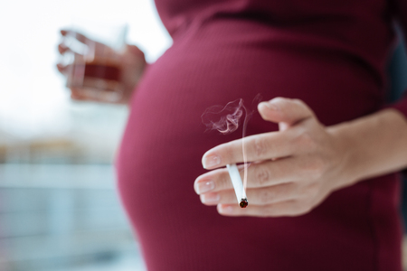 Close up of frivolous woman expecting childの写真素材