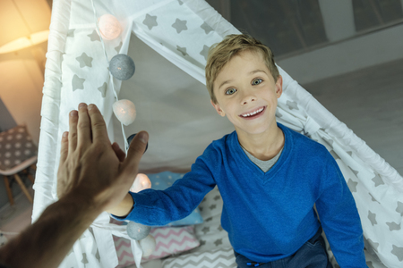Happy kid touching hands with fatherの写真素材