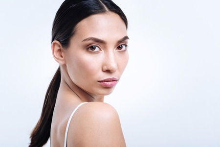 Close up of dark-haired young woman with a pony tailの写真素材