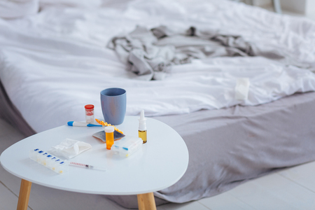 Pretty little table being covered with medicinesの写真素材