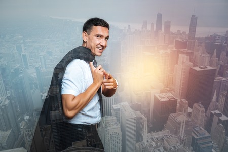 Positive confident businessman holding his jacketの写真素材