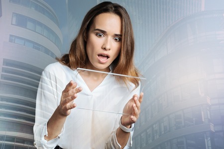 Nice surprised woman using a tabletの写真素材