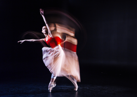 Grace and elegance. Nice beautiful attractive woman closing her eyes and dancing while being involved in the activityの写真素材