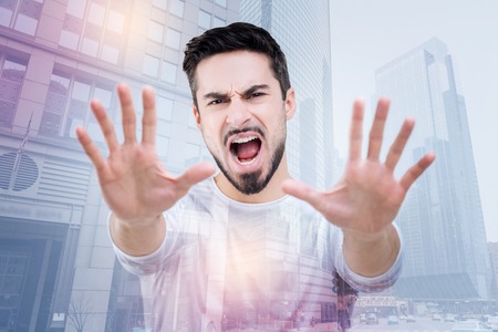 Not again. Stubborn emotional expressive young man showing his protest against going to a dentist while standing and pushing his hands in front of himの写真素材