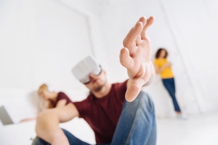 In frustration. Silhouette of young man that crossing legs while sitting on the floor and being deep in thoughtsの写真素材