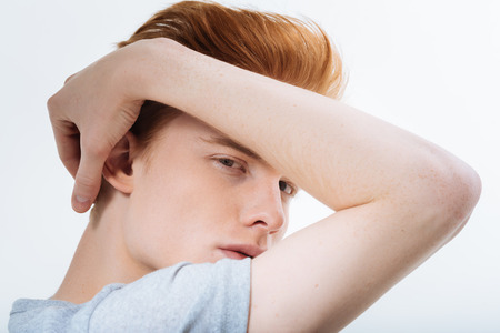 Young sensitive pensive guy caressing her hair while hypnotizing with look and seducing girlsの写真素材