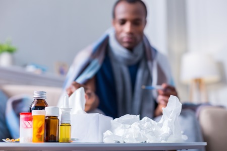 Medical treatment. Selective focus of medicine standing on the bedside table near paper tissues