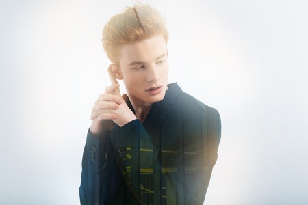Like a Bond. Young professional handsome model looking aside gesticulating and posing.