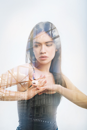 Morning exercises. Calm responsible serious person feeling good while standing with her hands crossed and doing usual morning exercisesの写真素材