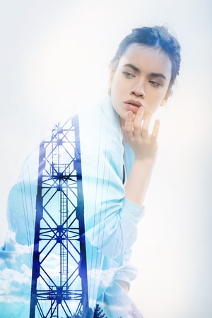 Difficult decision. Clever serious attentive student looking into the distance and slightly touching her lips while making an important decisionの写真素材