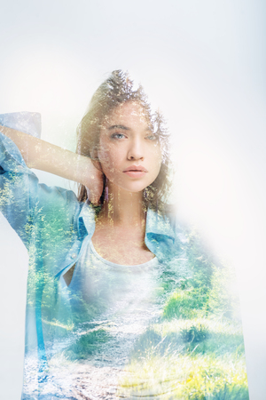 Pretty model. Cute young professional model touching her neck and looking amazing while being photographedの写真素材