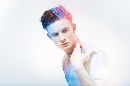 Skilled model. Young professional man model feeling confident while being at work and posing for a...