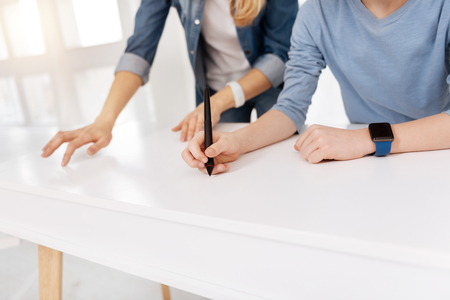 Sensory technology. Close up of a stylus pen being in hand of a smart cute young boy while using new technologiesの写真素材
