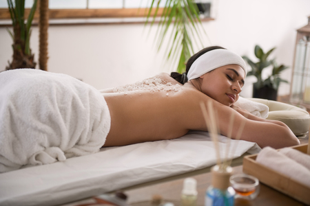 Absolute relaxation. Pleasant nice young woman closing her eyes while resting in the spa salon