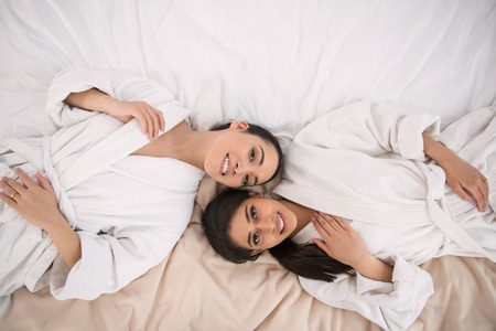 Pleasurable day off. Delighted happy women smiling to you while visiting the spa on their day offの写真素材