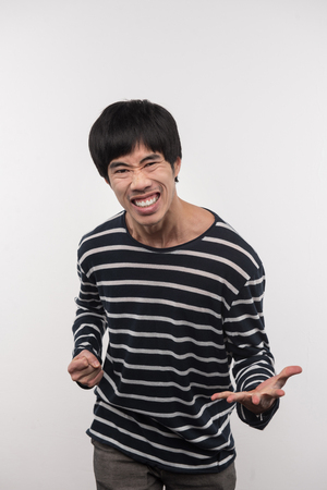 Pleasant emotions. Delighted Asian man looking at you while feeling happyの写真素材