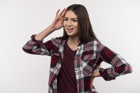 Emotional expression. Nice young woman touching her head while expressing her emotionsの写真素材