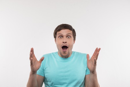 Positive mood. Delighted nice man gesticulating with his hands while feeling happy