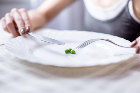 Three peas. Close up of a breakfast meal being eaten by a nice pleasant womanの写真素材