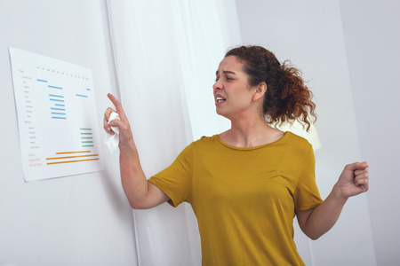 Keeping trace. Young girl carefully studying her calendar helping her keep trace of the medication frequencyの写真素材