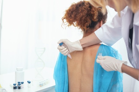 Skincare practice. Intern doctor collecting patients skin samples for a prefessional medical analysisの写真素材