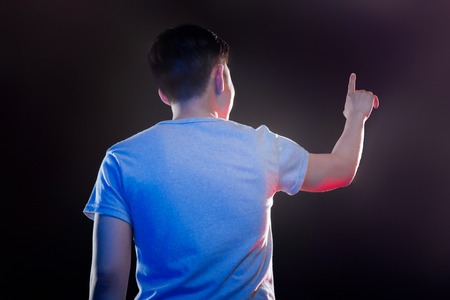 Visual media. Smart Asian man turning to the screen while working on itの写真素材