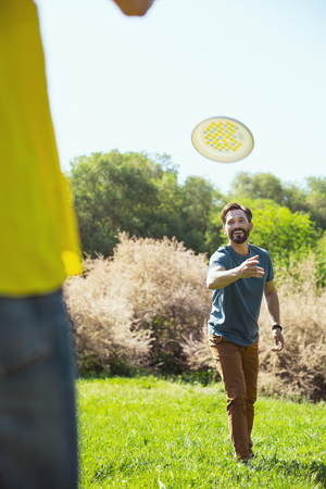 Entertainment. Content athletic husband smiling while playing a game with his wifeの写真素材