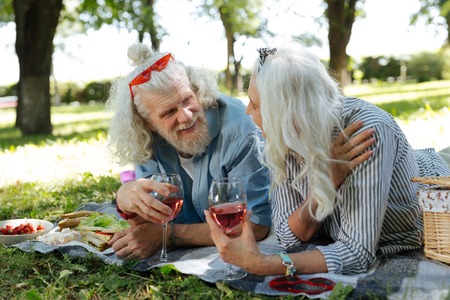 Pleasant communication. Delighted nice couple enjoying wine while having a pleasant conversationの写真素材