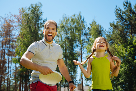 Best daddy. Content loving father smiling and playing a game with his kidsの写真素材