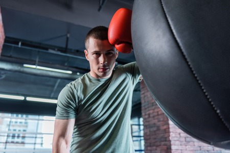 Long workout. Good-looking muscle dark-haired athlete enjoying his long workout during weekendの写真素材