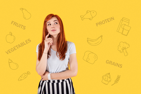 Good diet. Cheerful pretty actress looking into the distance and smiling happily while enjoying her new dietの写真素材
