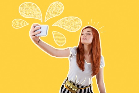Pretty selfie. Beautiful relaxed young girl feeling good and smiling while taking selfies during the journeyの写真素材
