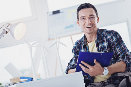 Follow me. Joyful invalid keeping smile on face while making notesの写真素材