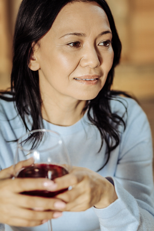 Calm down. Pretty woman overthinking while sitting in a cafeの写真素材