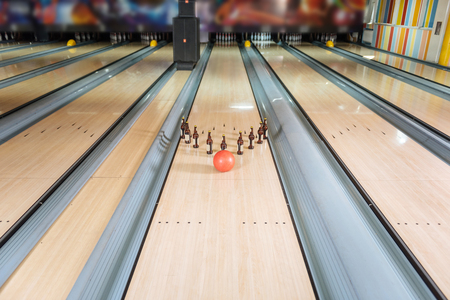 Bowling game. Top view of a bowling ball hitting bottles of beerの写真素材