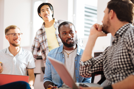 Interesting people. Smart curious students attending an interesting seminar and enjoying their emotional discussion while sitting in a classroomの写真素材