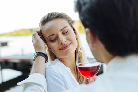Absolutely happy. Nice positive woman closing her eyes from happiness while being together with her...