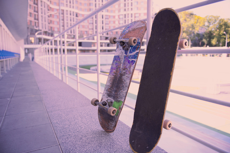 Gadgets for activity. Old skateboards leaning on holders while being in standing positionの写真素材