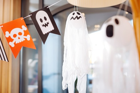 Scary ghosts. Scary ghosts and flags with skulls lying as decorations for Halloween children party