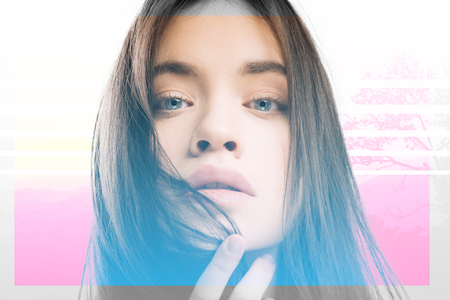 Tender touch. Pretty young beautiful model posing for a photo and thoughtfully touching her lipsの写真素材