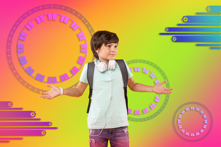 Right choice. Glad doubtful boy spreading out hands and gazing asideの写真素材