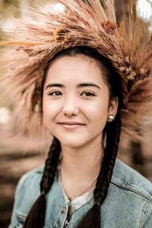 Natural beauty. Amazing Asian female person wearing diadem and demonstrating her smile