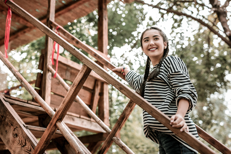 Happy interaction. Pleased girl standing in semi position and looking sidewaysの写真素材