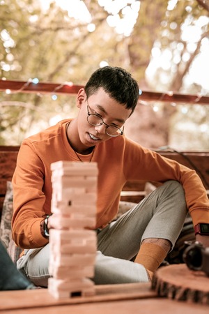 Stylish hipster. Pleased male person bowing head while looking forwardの写真素材