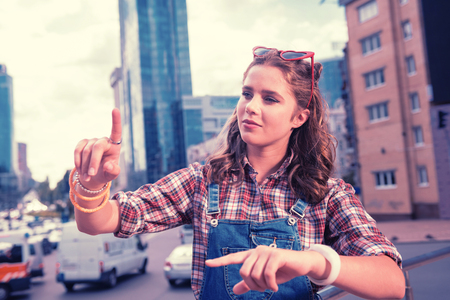 Rings and bracelets. Curly dark-haired high school girl wearing nice rings and bracelets while loving fashion and shoppingの写真素材