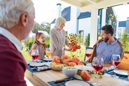 Made with love. Happy girl keeping mouth opened while looking at her daddyの写真素材